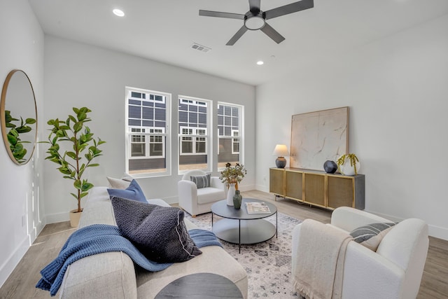 living room with ceiling fan and light wood-type flooring