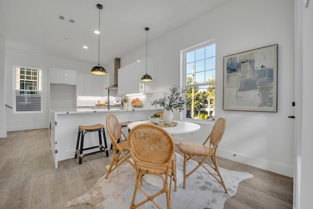 dining space featuring light wood-type flooring