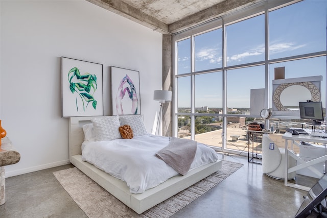 bedroom featuring concrete floors and a towering ceiling