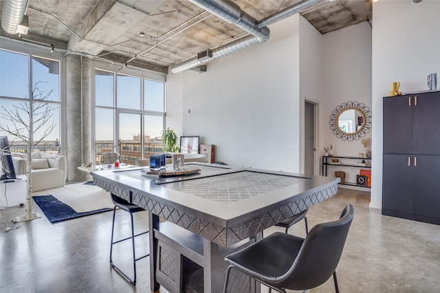 kitchen with a breakfast bar area and a high ceiling