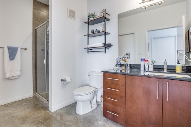 bathroom with concrete floors, vanity, a shower with shower door, and toilet