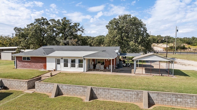 rear view of property featuring a yard and a patio area