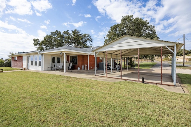 2720 N US-377, Stephenville, TX 76401 - rear view of property with a lawn, brick siding, a patio area, and a carport