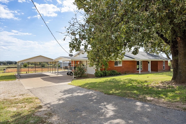 2720 N US-377, Stephenville, TX 76401 - view of front of home featuring fence, aphalt driveway, a front lawn, brick siding, and a carport