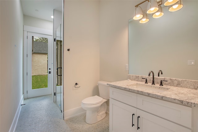 bathroom featuring vanity, a chandelier, toilet, and tile patterned floors