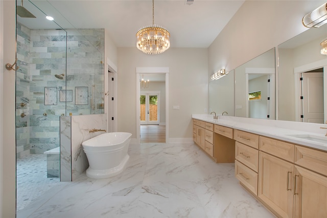 bathroom featuring vanity, independent shower and bath, and an inviting chandelier