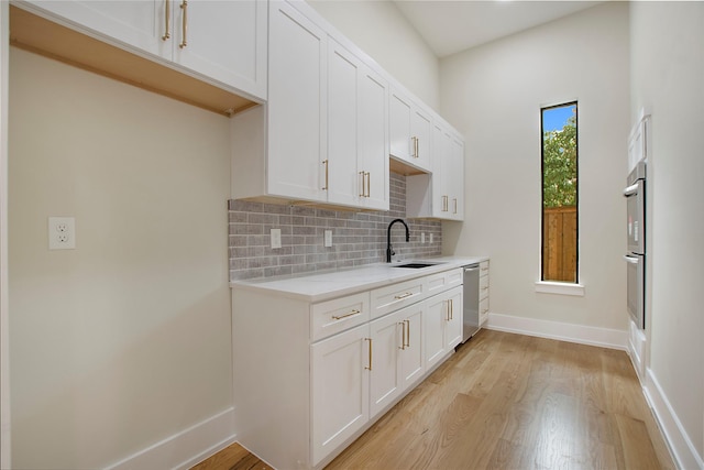 4208 Allencrest, Dallas, TX 75244 - kitchen with baseboards, light wood-type flooring, tasteful backsplash, a sink, and stainless steel appliances