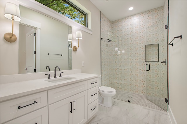 bathroom with vanity, toilet, and walk in shower