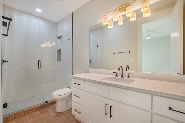 bathroom with vanity, toilet, tile patterned floors, and walk in shower