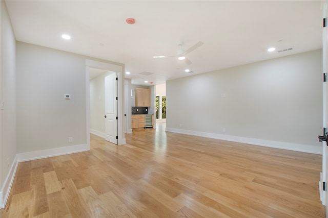 unfurnished living room featuring ceiling fan and light hardwood / wood-style flooring