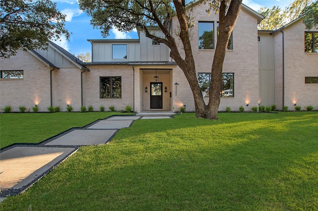 4208 Allencrest, Dallas, TX 75244 - view of front of home featuring board and batten siding, a front lawn, and brick siding