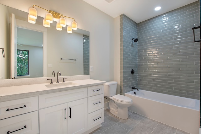 full bathroom with vanity, toilet, tile patterned flooring, and tiled shower / bath