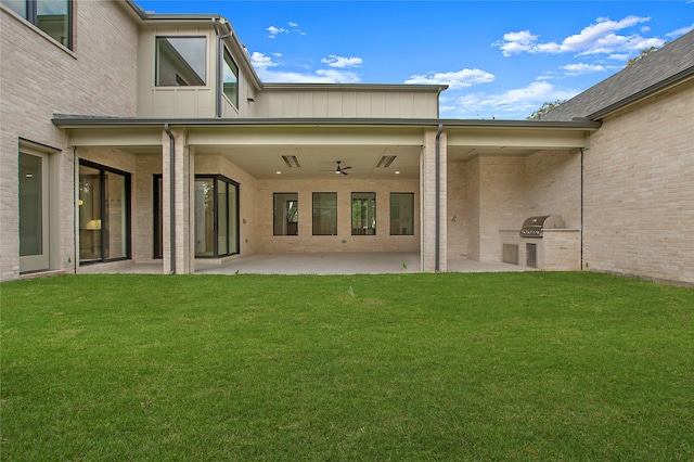 back of house with a patio area, area for grilling, a lawn, and ceiling fan