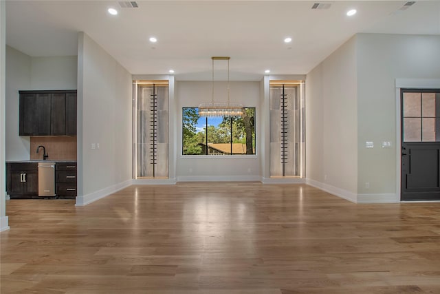 4208 Allencrest, Dallas, TX 75244 - unfurnished living room with recessed lighting, baseboards, a sink, and light wood-style flooring