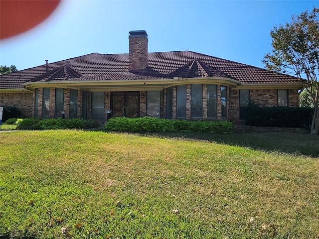 back of property featuring a yard