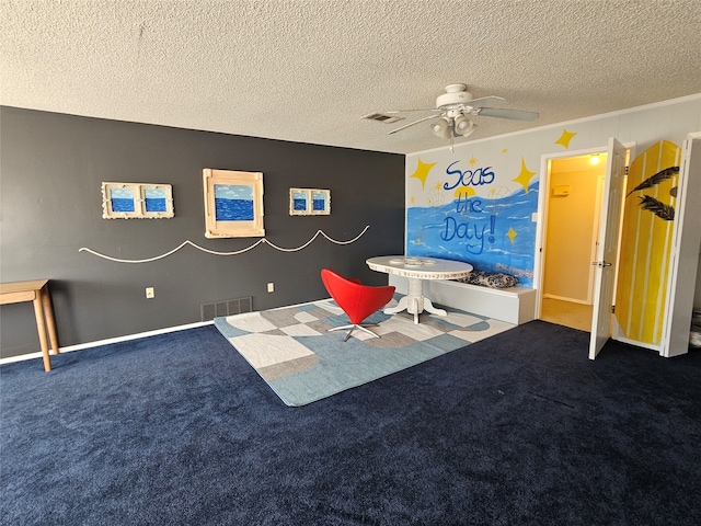 game room with ceiling fan, a textured ceiling, and carpet floors