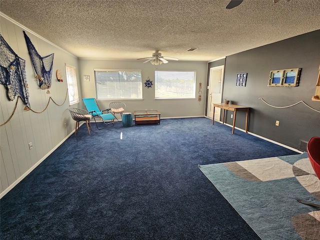 unfurnished room featuring dark colored carpet, a textured ceiling, and ceiling fan