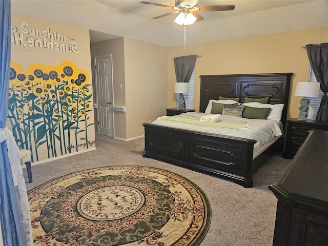 carpeted bedroom featuring ceiling fan and a textured ceiling