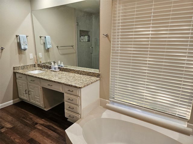 bathroom with vanity, shower with separate bathtub, and wood-type flooring