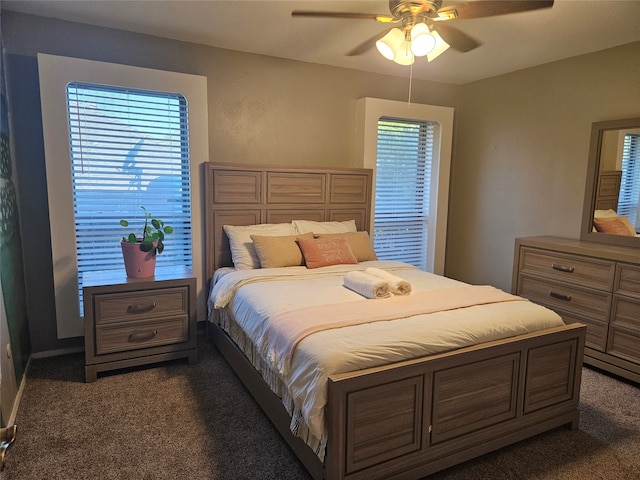 bedroom featuring dark colored carpet and ceiling fan