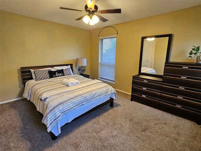 carpeted bedroom with a textured ceiling and ceiling fan