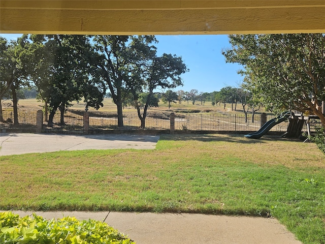 view of yard with a playground and a rural view