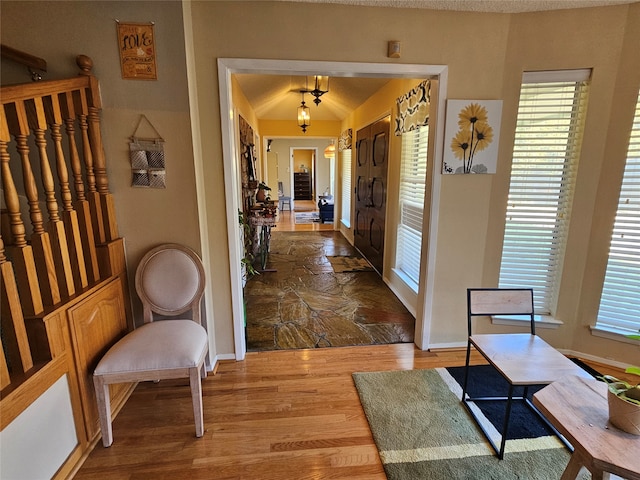 corridor with hardwood / wood-style flooring