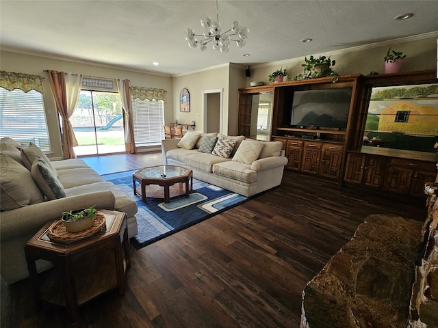 living room featuring ornamental molding, dark wood-type flooring, a notable chandelier, and a textured ceiling