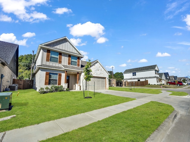 craftsman-style house with a front yard and central AC unit