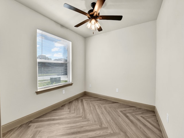 empty room featuring light parquet flooring and ceiling fan