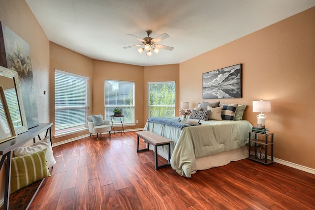 bedroom with dark hardwood / wood-style floors and ceiling fan