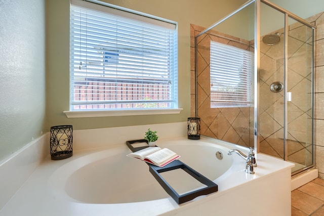 bathroom with tile patterned floors and shower with separate bathtub