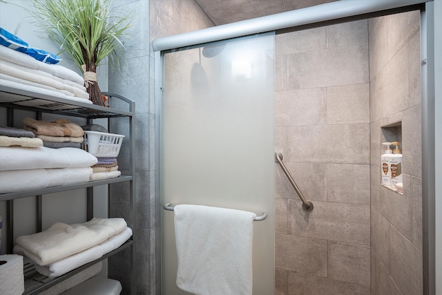 bathroom with a shower with shower door