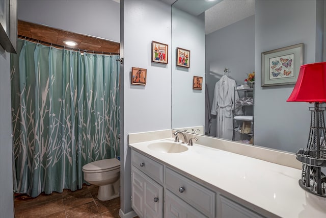 bathroom featuring a textured ceiling, toilet, vanity, a shower with shower curtain, and tile patterned flooring