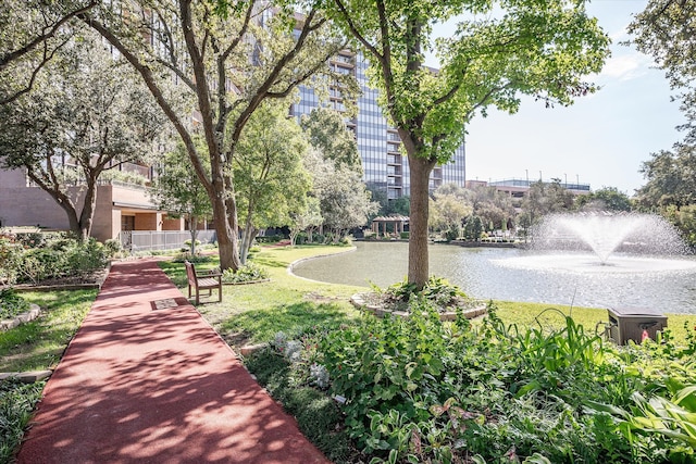 view of property's community featuring a water view and a lawn