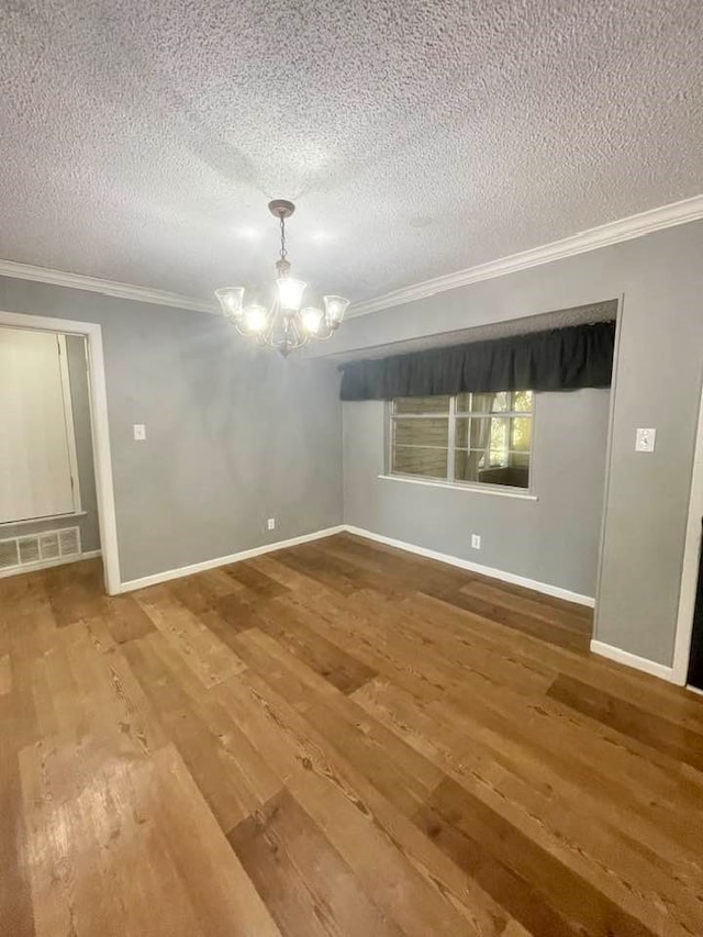 unfurnished room featuring ornamental molding, a textured ceiling, and hardwood / wood-style flooring