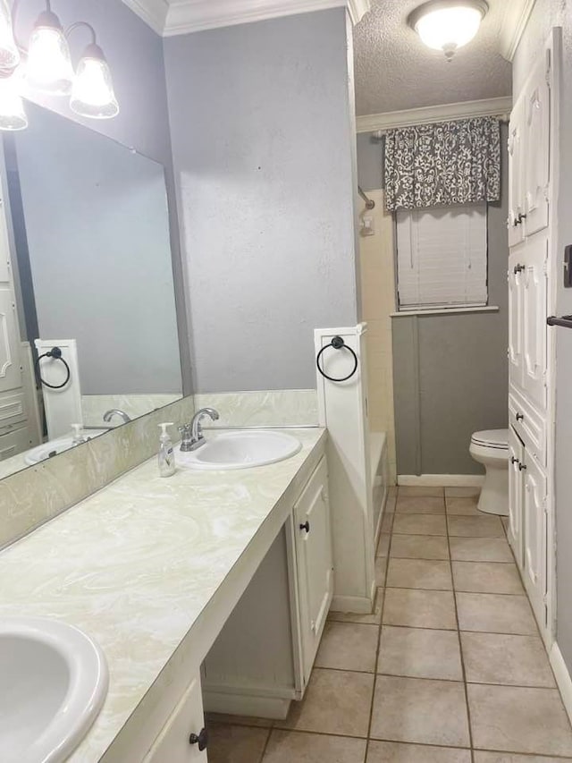 full bathroom with vanity, crown molding, toilet, and tile patterned floors