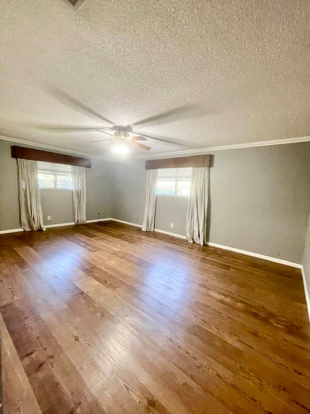 empty room featuring a textured ceiling, hardwood / wood-style flooring, and ceiling fan