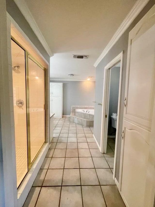 hallway featuring crown molding and light tile patterned floors