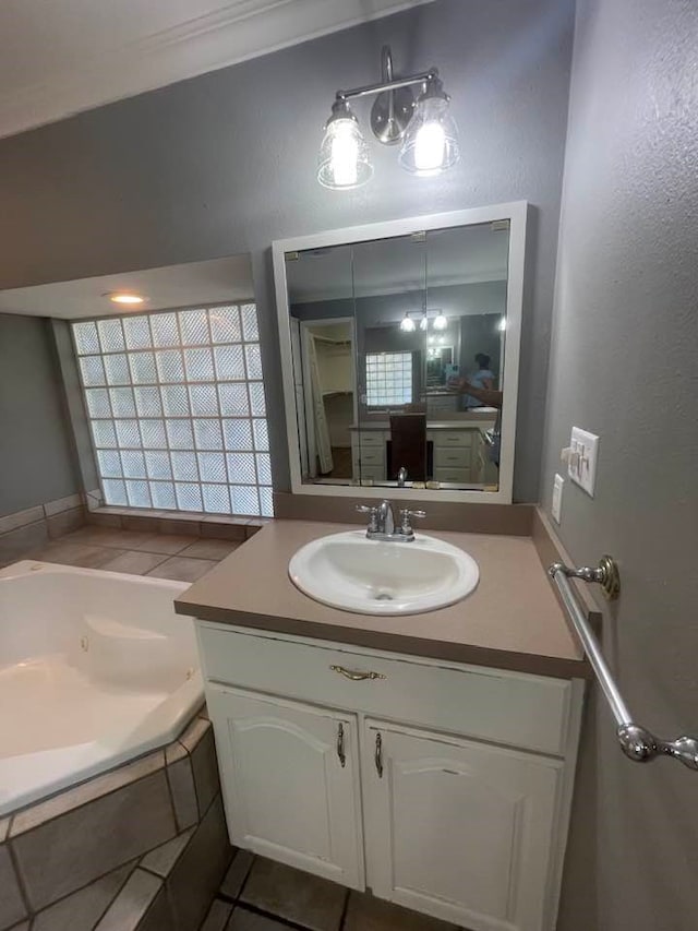 bathroom featuring vanity, a bath, and tile patterned floors