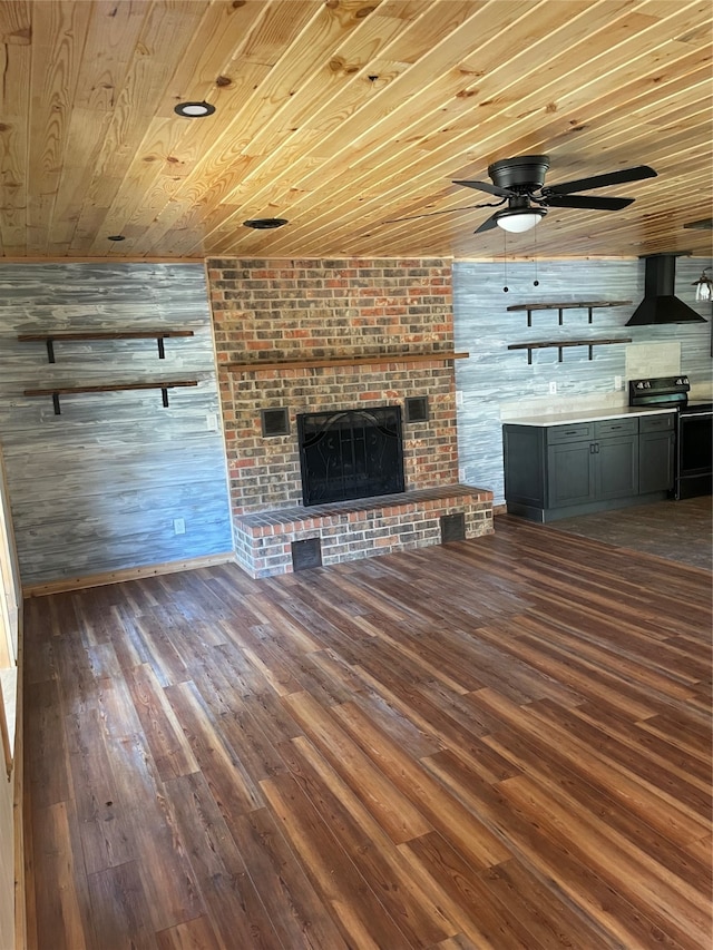 unfurnished living room featuring a fireplace, dark hardwood / wood-style flooring, wooden walls, and wood ceiling