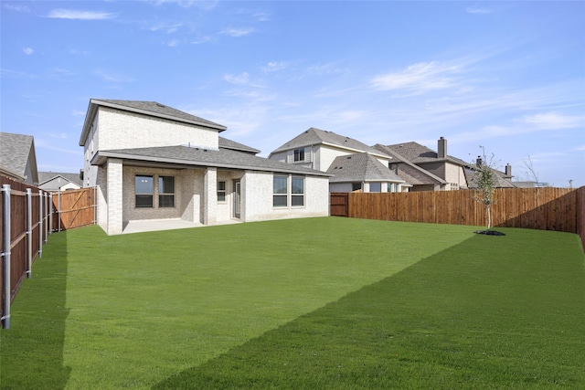 rear view of property with a yard