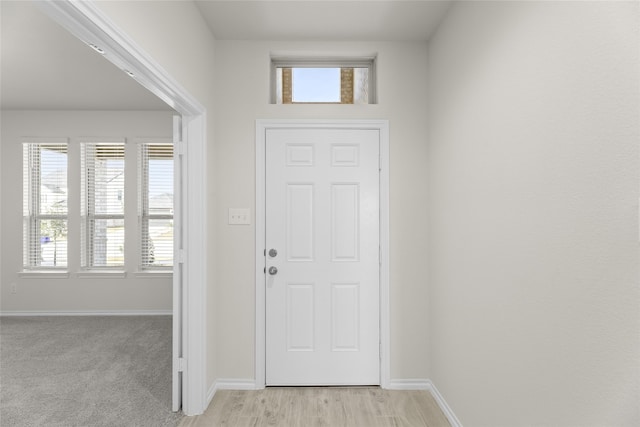 foyer featuring light colored carpet