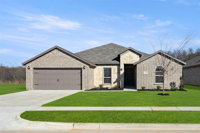 view of front of home with a garage and a front yard