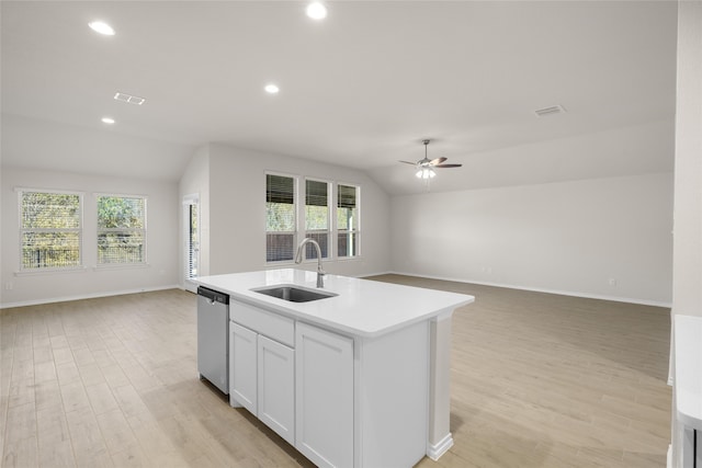 kitchen with dishwasher, lofted ceiling, a healthy amount of sunlight, and an island with sink