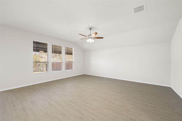 unfurnished room featuring light wood-type flooring, vaulted ceiling, and ceiling fan