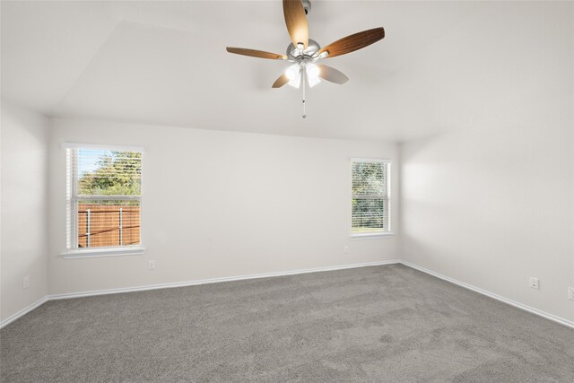 carpeted empty room featuring plenty of natural light and ceiling fan