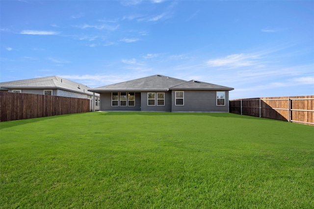 back of house with a lawn