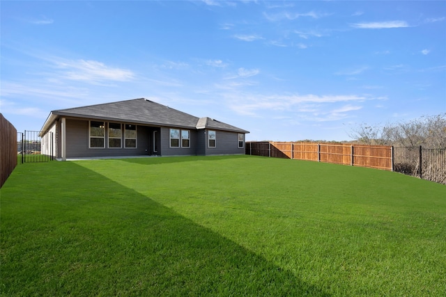 rear view of property featuring a yard