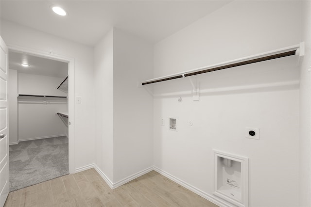 laundry room featuring hookup for an electric dryer, washer hookup, gas dryer hookup, and light hardwood / wood-style flooring